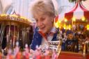 The Dean of Norwich, the Very Rev Jane Hedges, takes a look at a vintage model christmas fairground at the first Norfolk Christmas Fayre at Norwich Cathedral. Picture: DENISE BRADLEY