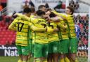 Norwich City players celebrate Ashley Barnes' match-clinching goal in a 3-0 Championship win over Stoke City