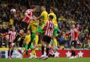 Norwich City's Shane Duffy (centre) attempts a shot at goal