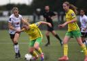 Norwich City's Katie Knights is held back as she wins the ball