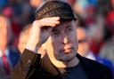 Elon Musk listens as Republican presidential nominee Donald Trump speaks at a campaign event (Alex Brandon/AP)