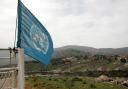 A Unifil flag fluttering over southern Lebanon (Alamy/PA)