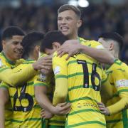 Norwich City players celebrate Christian Fassnacht sealing a 4-1 Championship win over Cardiff City