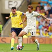 Josh Sargent and Elliott Moore compete for the ball