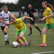 Norwich City's Katie Knights is held back as she wins the ball