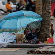 A woman sleeps on Beirut’s corniche after fleeing Israeli airstrikes in Dahiyeh, Lebanon (Bilal Hussein/AP)